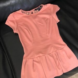Pastel pink peplum top with cute back lace detail.
